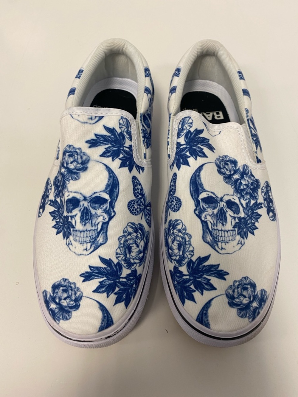 White Slip-On Women’s Sneakers with Blue Skull & Floral Print